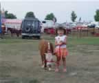 Our 3 year old daughter with Jewel, a 5 month old heifer calf, at the 2006 Rockingham County Fair.